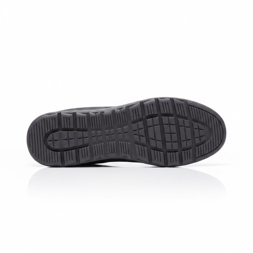Bottom view of a black men's knit barefoot shoe showing the patterned traction outsole.