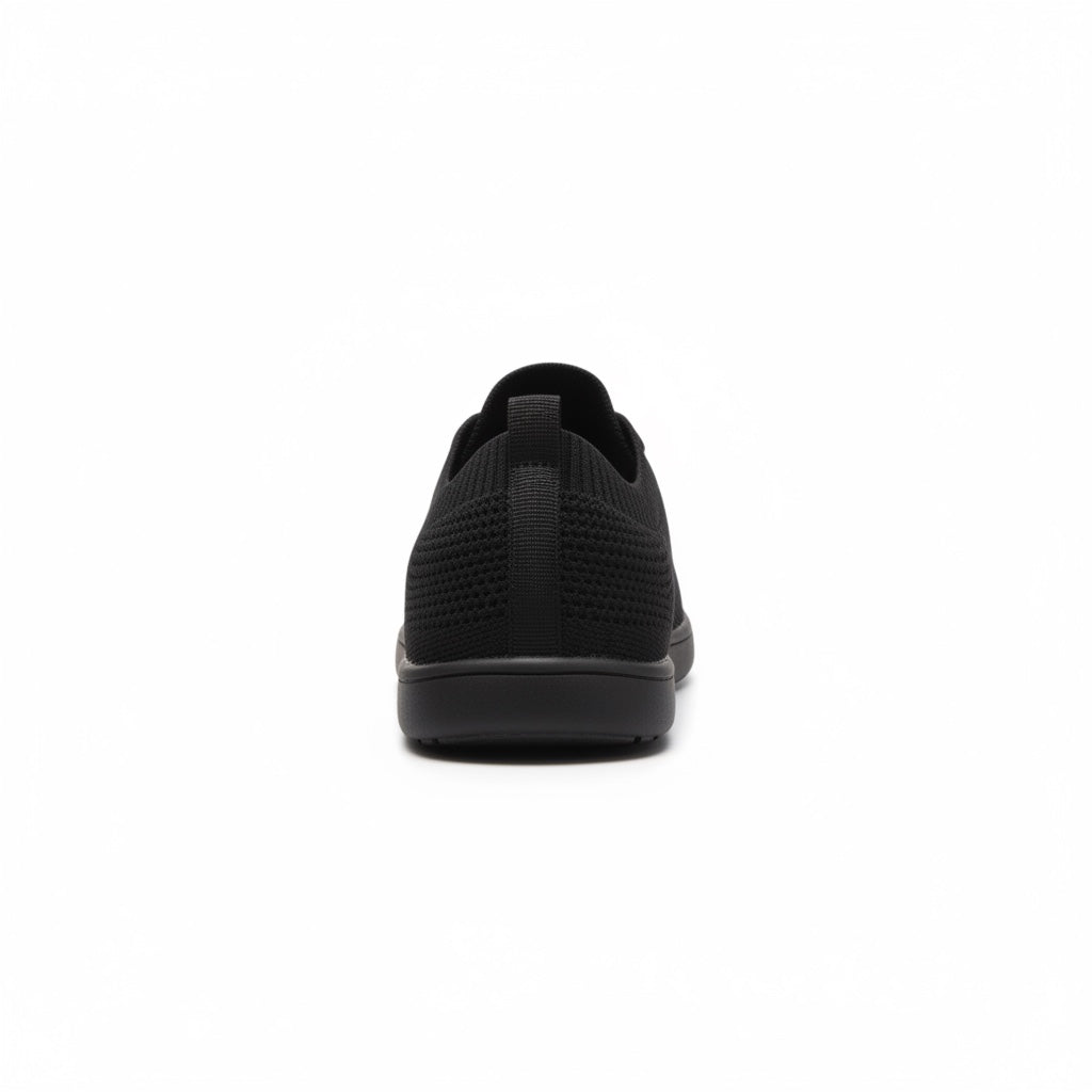 Rear view of a black men's knit  barefoot shoe showing the heel and textured upper.