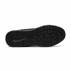 Bottom view of a black men's knit barefoot shoe showing the patterned rubber outsole.