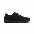 Black men's knit Barefoot Shoe with lace up closure and textured rubber sole, shown from the side.