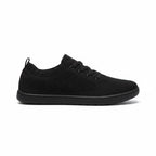 Black men's knit Barefoot Shoe with lace up closure and textured rubber sole, shown from the side.