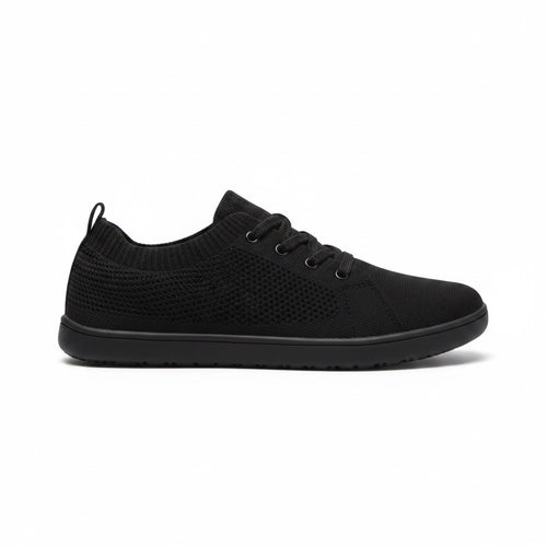 Black men's knit Barefoot Shoe with lace up closure and textured rubber sole, shown from the side.