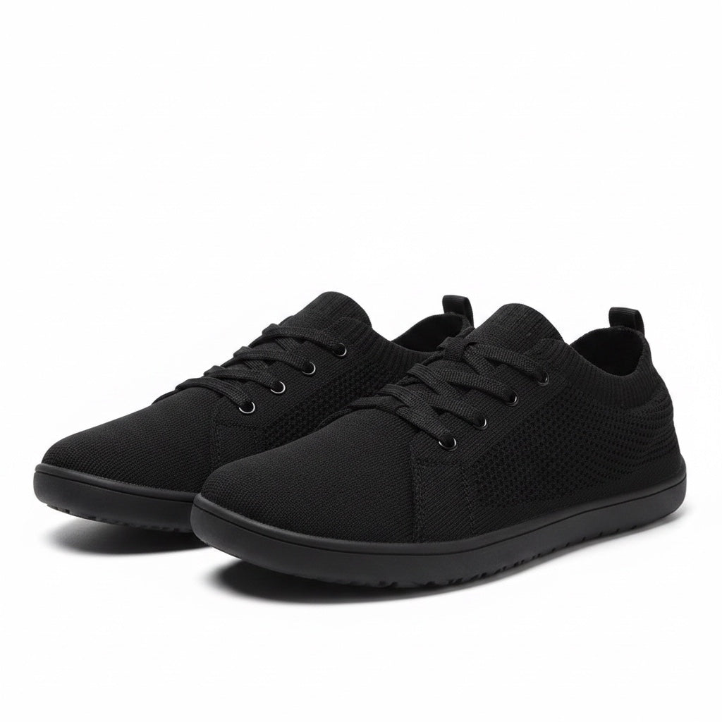 Pair of black men's knit barefoot shoes with lace-up fronts and lightweight rubber soles.