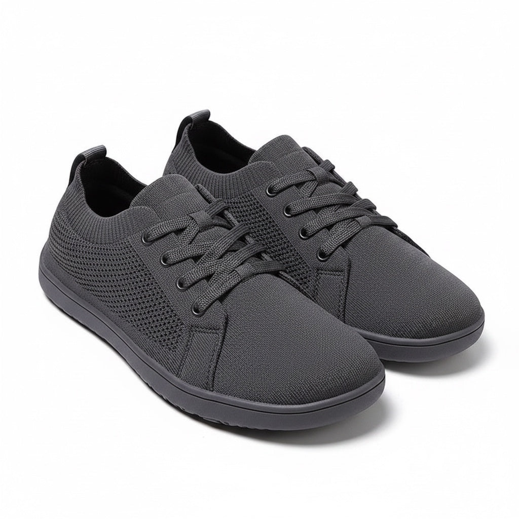 Pair of black men's knit casual barefoot shoes displayed at an angled view