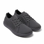 Pair of black men's knit casual barefoot shoes displayed at an angled view