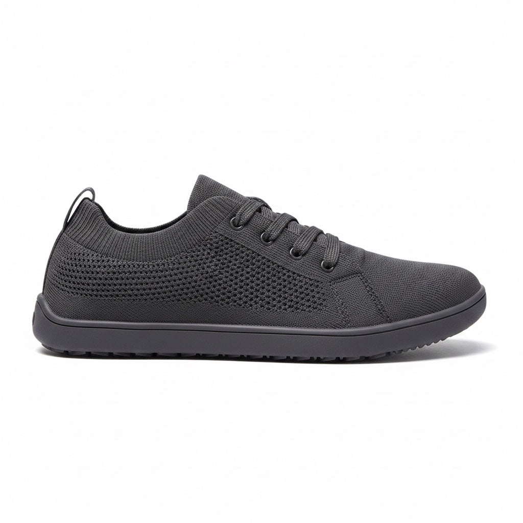Black men's knit barefoot shoes shown in side profile with a streamlined upper and textured rubber sole.