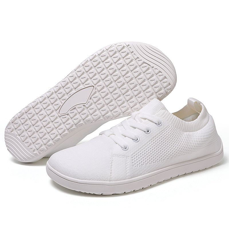 White barefoot shoes with white sole and laces, wide toe for natural movement.