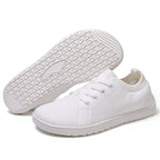 White barefoot shoes with white sole and laces, wide toe for natural movement.