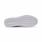 Bottom view of a white men's knit barefoot shoes showing the patterned rubber outsole.