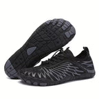 Angled pair of black  Nomad barefoot shoes highlighting the lightweight construction and flexible outsole.