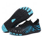 Pair of black and blue Nomad barefoot shoes showing their minimalist construction and flexible soles.