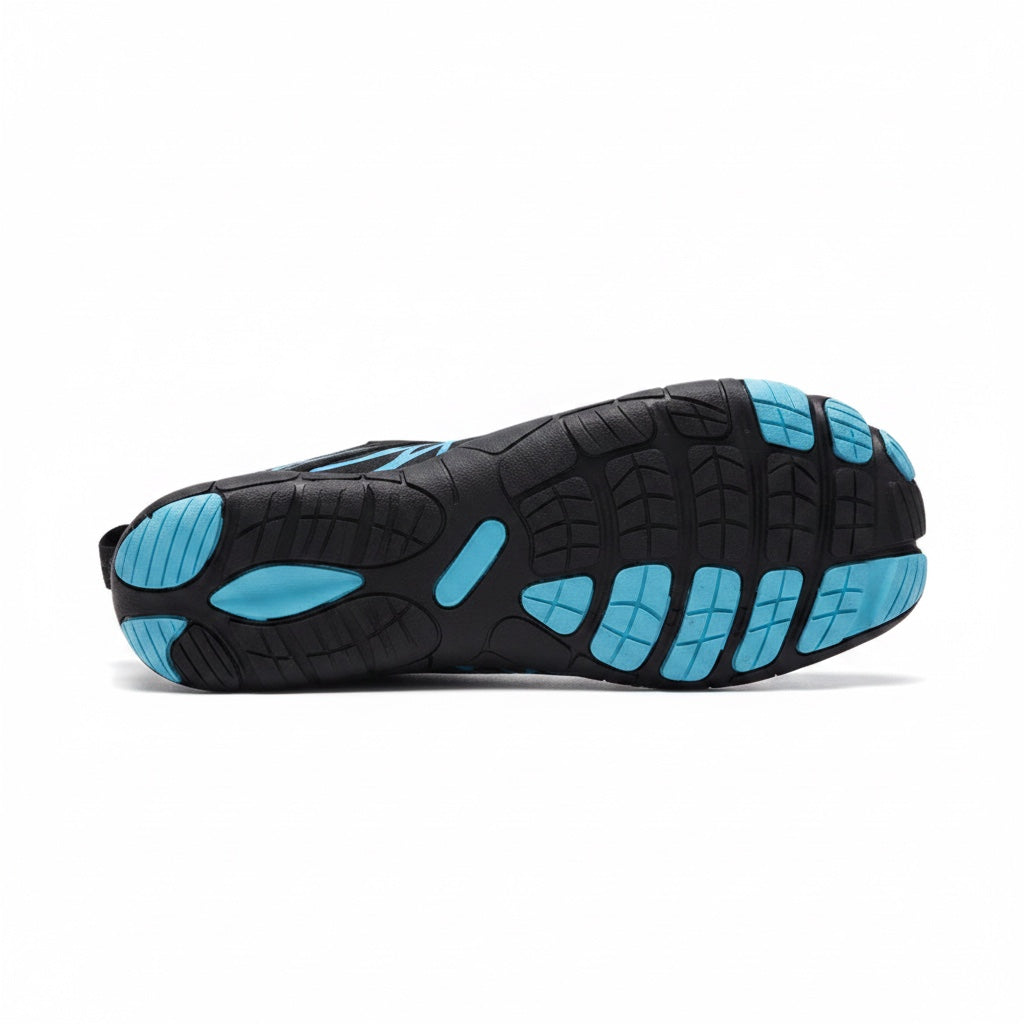 Bottom view of the black and blue Nomad barefoot shoe showing the textured flexible outsole.