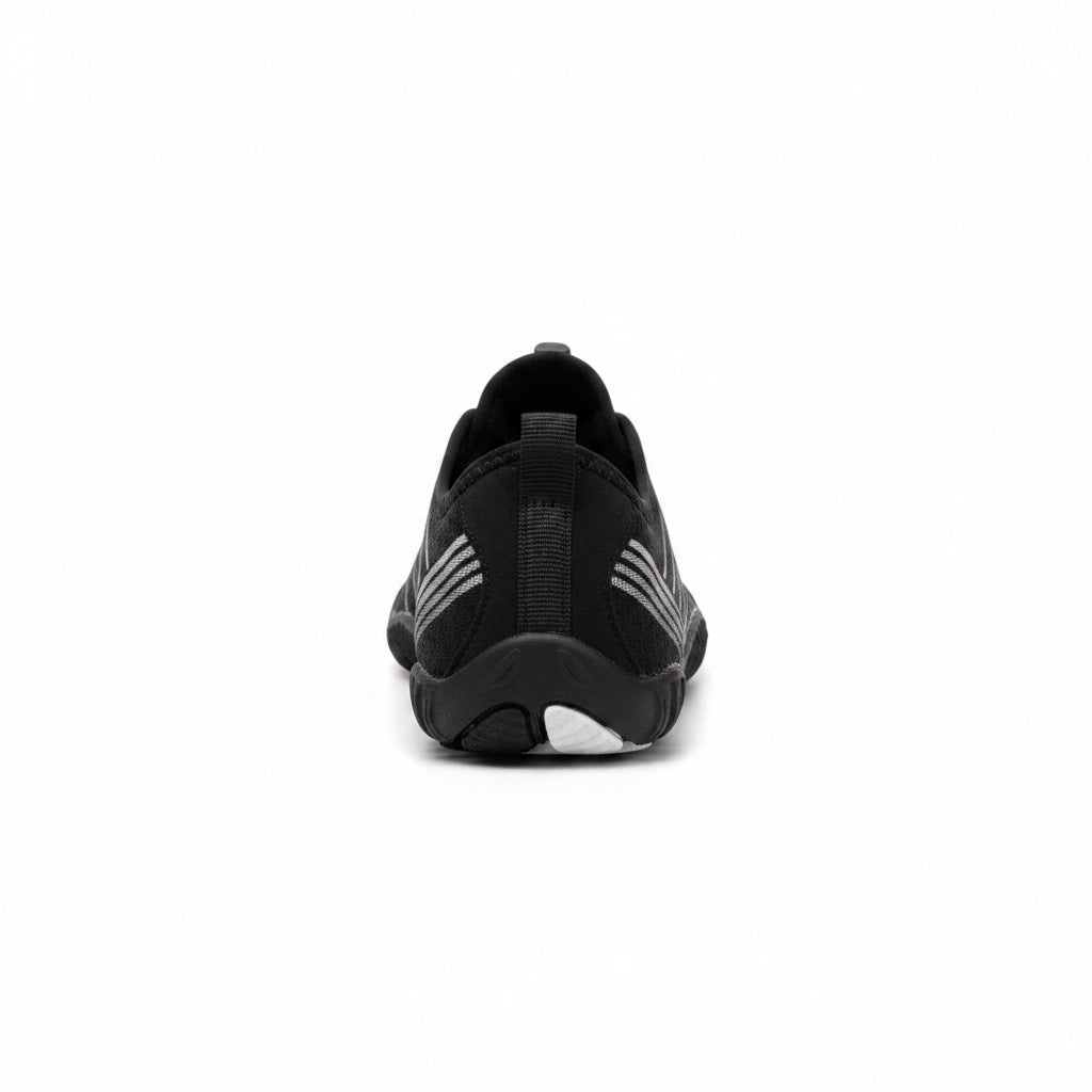 Rear view of the black Nomad barefoot shoe showing the heel structure and flexible outsole.