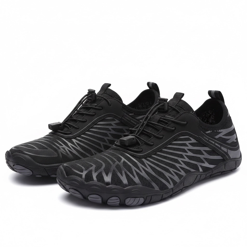 Pair of black Nomad barefoot shoes showing the minimalist shape and flexible sole design.