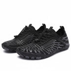 Pair of black Nomad barefoot shoes showing the minimalist shape and flexible sole design.