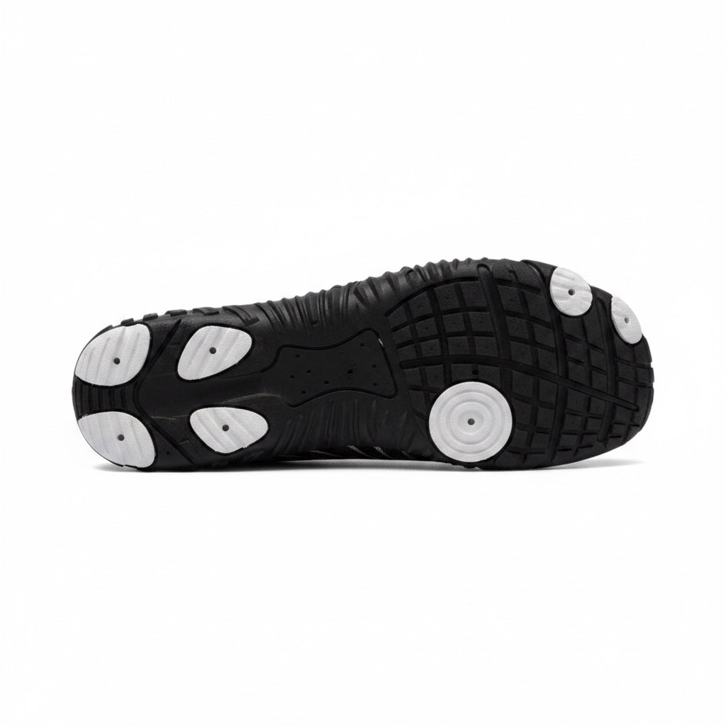 Bottom view of the black  Nomad barefoot shoe showing the textured outsole designed for flexibility and grip.