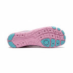 Bottom view of the pink Nomad barefoot shoe showing the textured flexible outsole and blue grip sections.