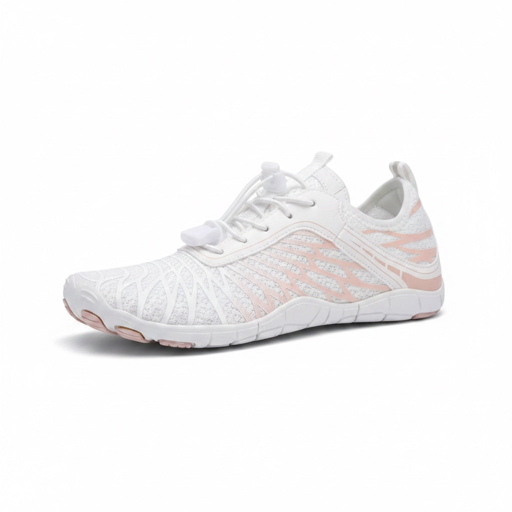 White Nomad barefoot shoes worn outdoors beside a lake, showcasing their versatile everyday design.