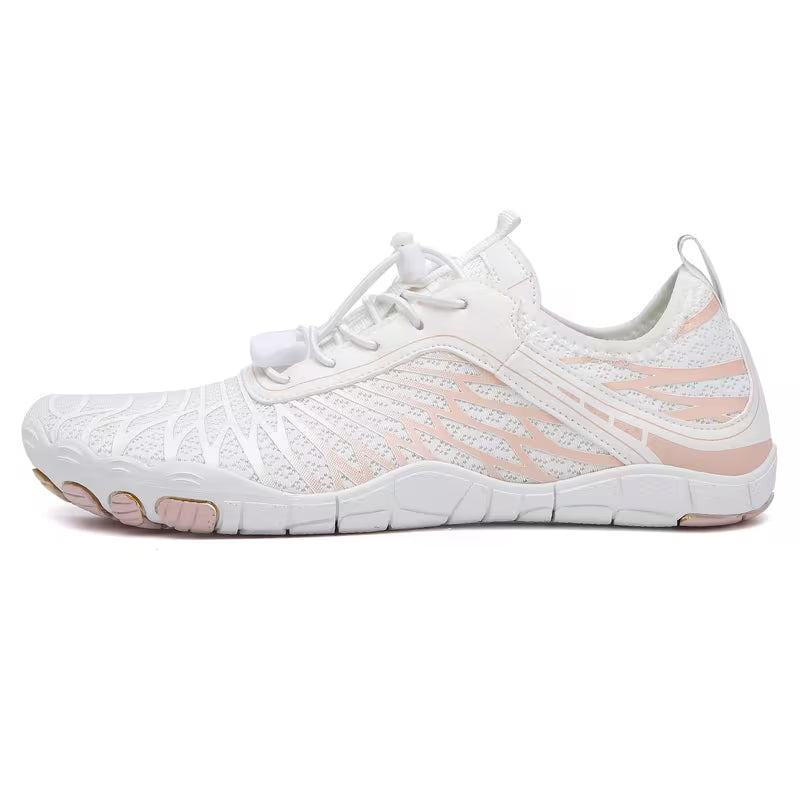 Pair of white Nomad barefoot shoes displaying their minimalist shape and flexible construction.