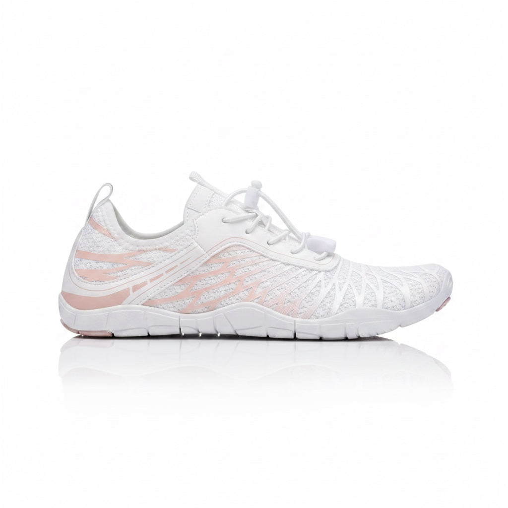 White Nomad barefoot shoe shown from the side, highlighting its lightweight construction and flexible sole.