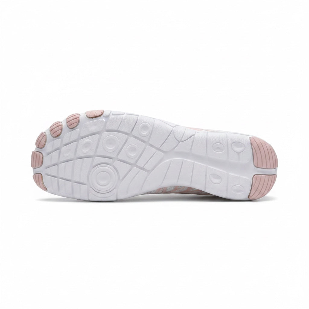 Bottom view of the white Nomad barefoot shoe showing the textured outsole designed for flexibility and grip.