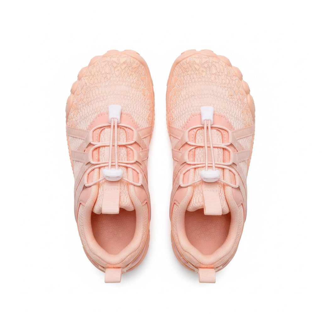 A pair of light Orange athletic sneakers shown from a top down view. 