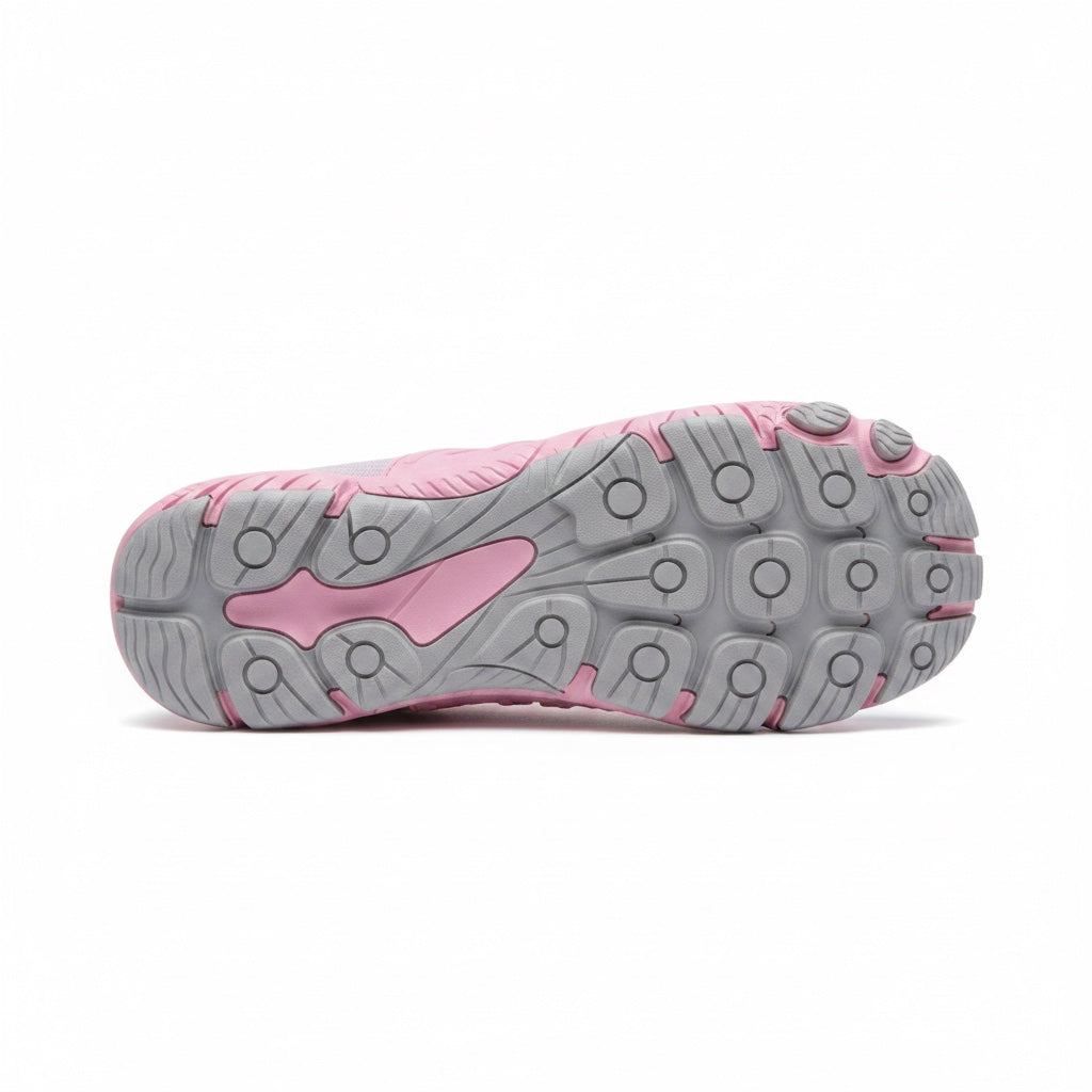 Bottom view of a pink barefoot shoe showing its flexible textured rubber sole