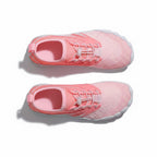 A pair of pink knit athletic sneakers shown from a top down view.