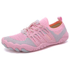 Pink unisex barefoot shoes shown from the side with breathable mesh and flexible soles