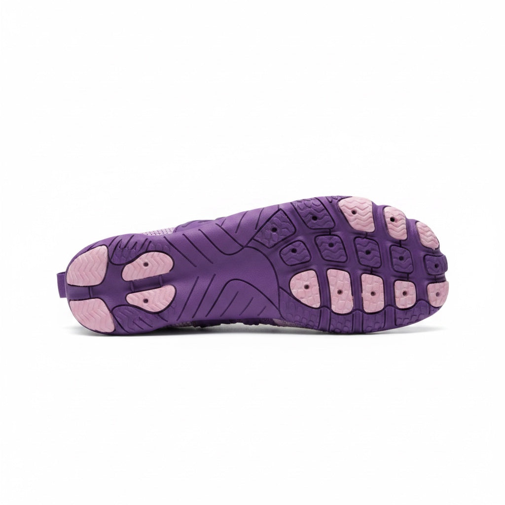 Bottom view of a purple barefoot shoe showing its textured flexible rubber sole