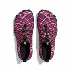 A pair of barefoot trail running shoes in a vibrant pink and purple geometric pattern, shown from a top down view.