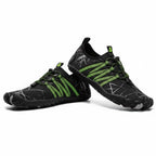 A pair of water shoes in black with bright neon green accents, including three stripes on the side, laces, and heel tab.