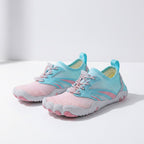 A pair of water shoes in pastel pink and light blue, featuring a breathable mesh upper, toe separators, and flexible soles, displayed on a clean white surface.