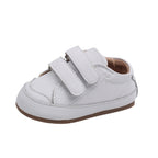 Side view of white baby shoes with double adjustable straps and flexible sole