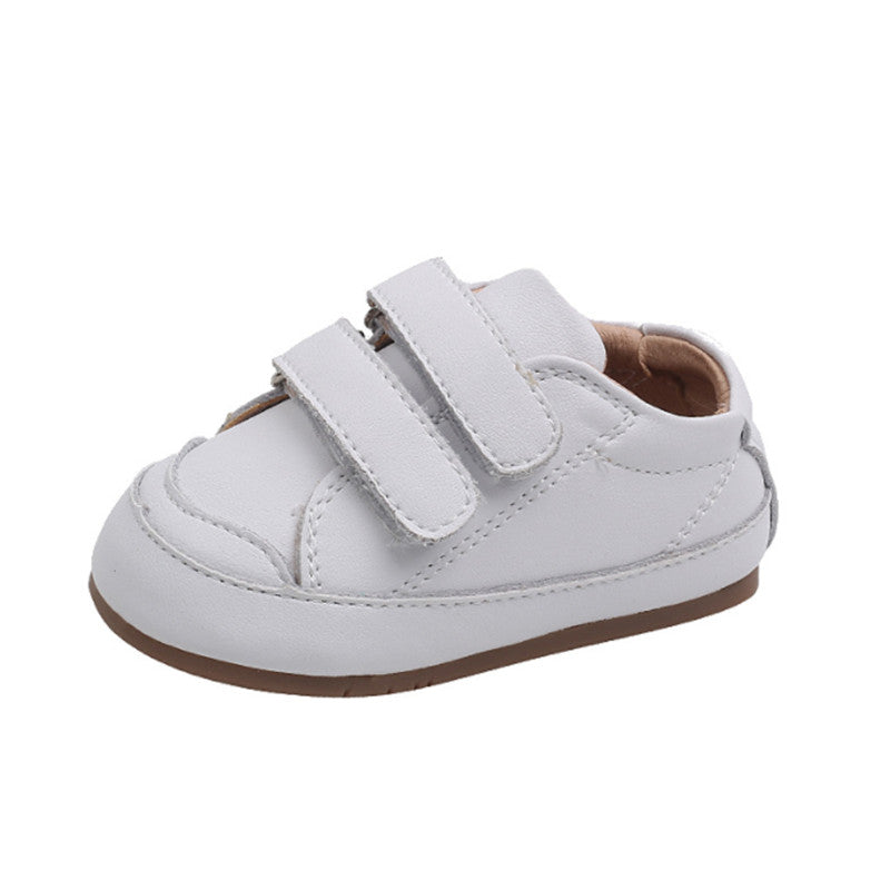 Side view of white baby shoes with double adjustable straps and flexible sole