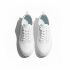 A pair of white low top lace up Barefoot shoes shown from a top down angle.