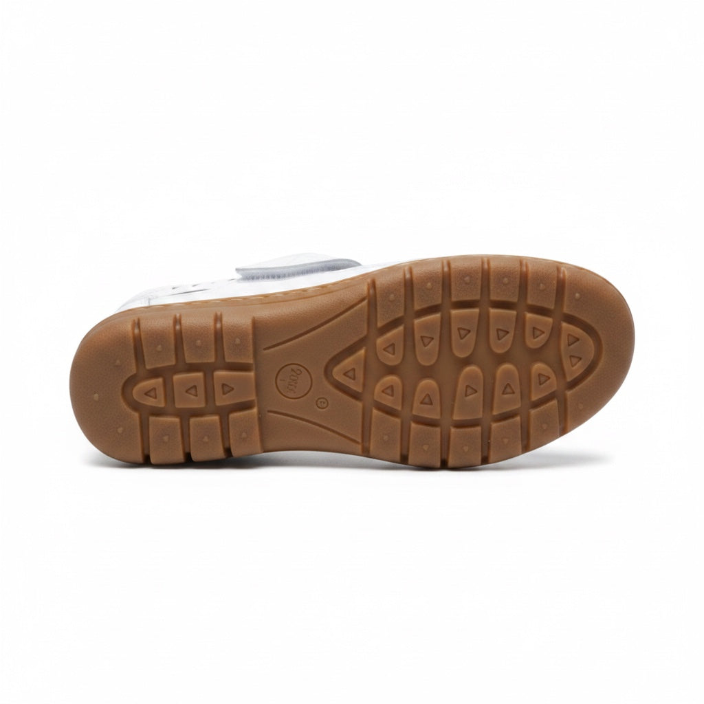 Bottom view of a white comfort sandal showing the textured brown rubber outsole