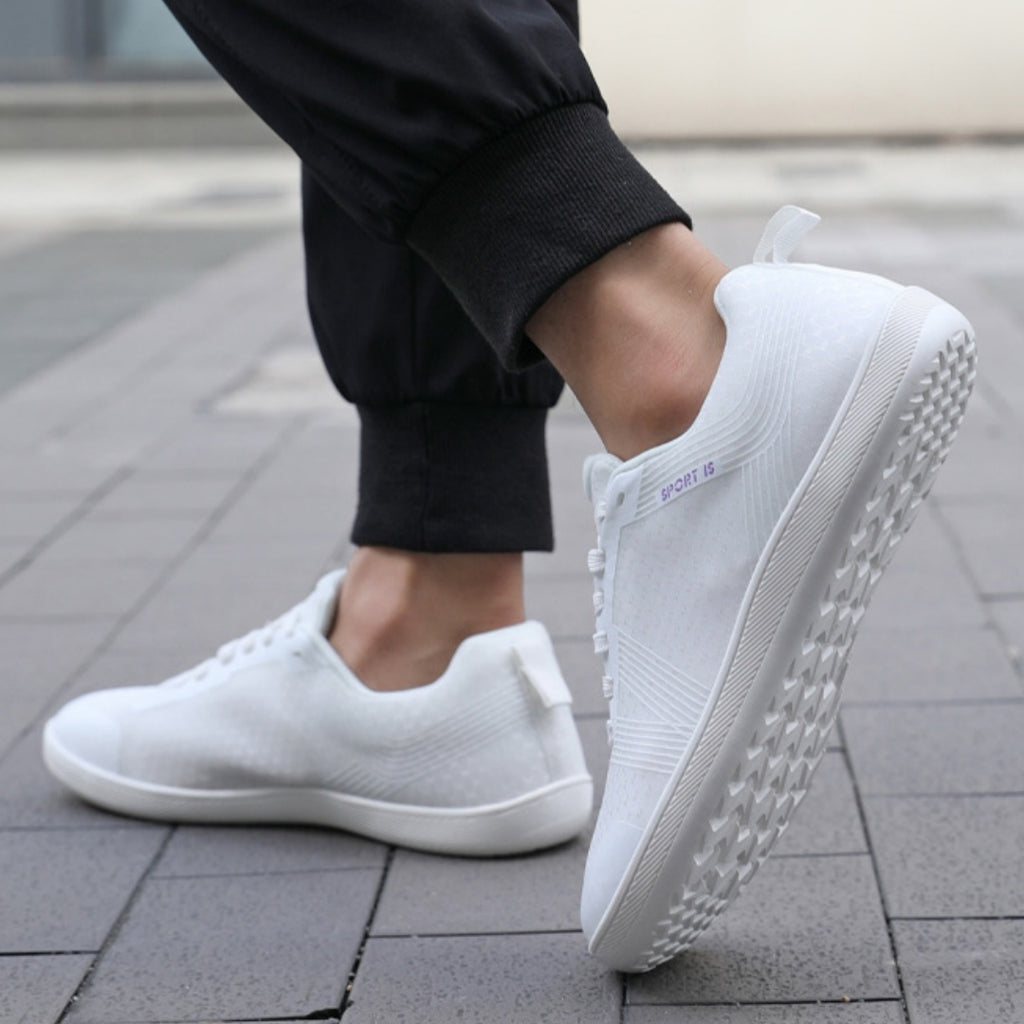 White Mens barefoot shoes worn by a model 