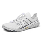 White barefoot shoe shown from the side, highlighting its breathable upper and natural foot-shaped design.
