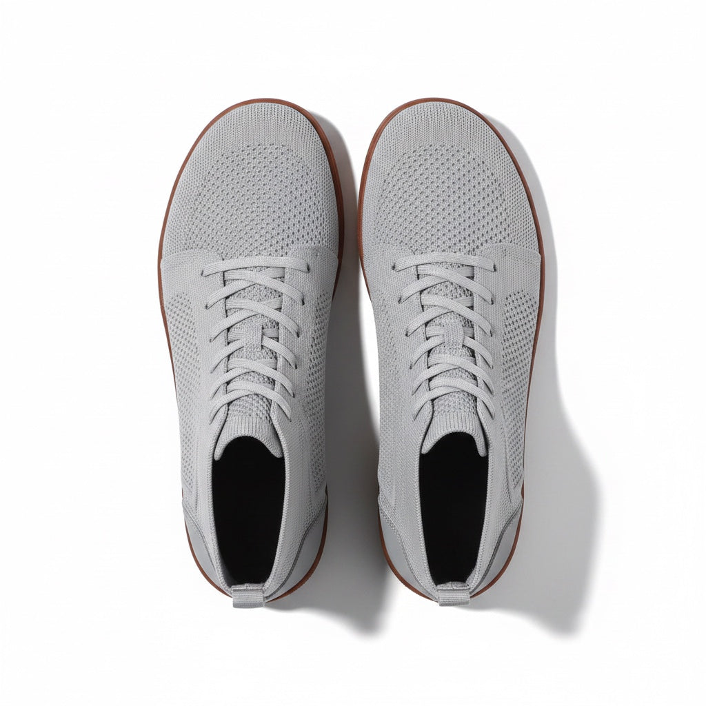 A pair of light grey knit lace up sneakers shown from a top-down view.